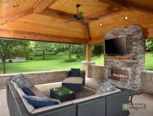 covered outdoor patio with wicker furniture and a view of a green lawn