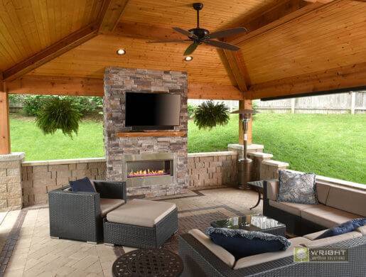 covered patio living space with electric fire place, tv, and wicker furniture